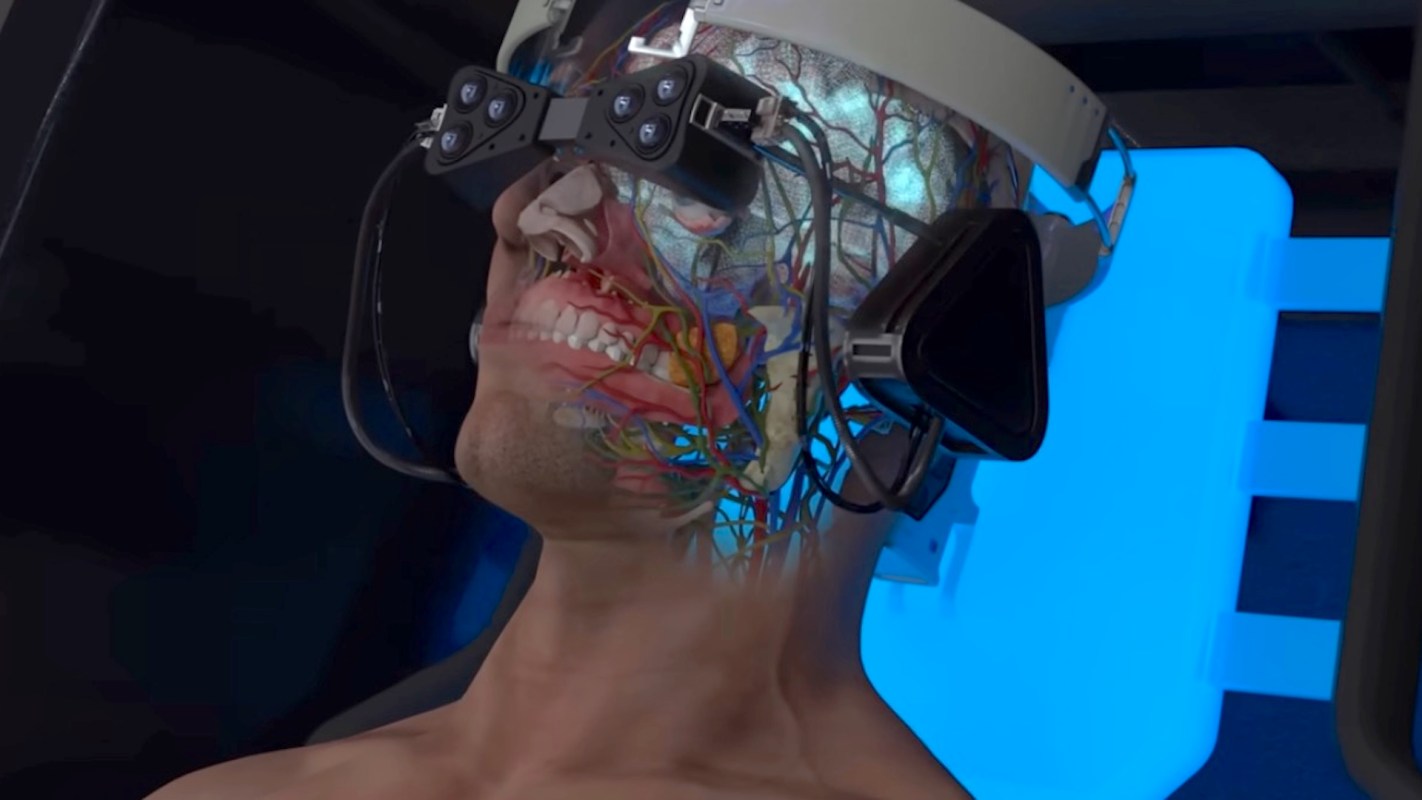 A person wearing a VR headset with a transparent face revealing internal anatomy and neural structures.