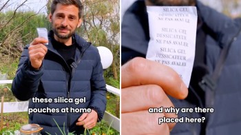 A man in a jacket holds a silica gel pouch, discussing its use at home, with greenery in the background.