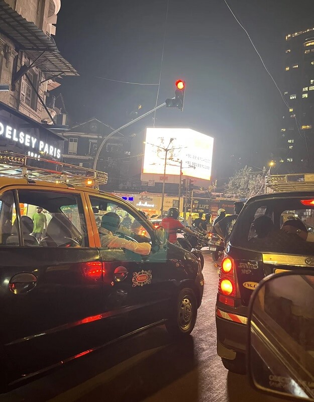 A very bright ad lights up a gridlocked road.