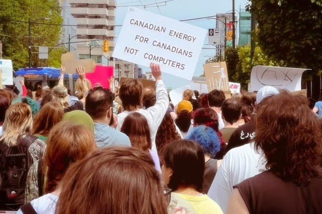 A diverse crowd of protesters holds signs, one reading "Canadian energy for Canadians not computers."