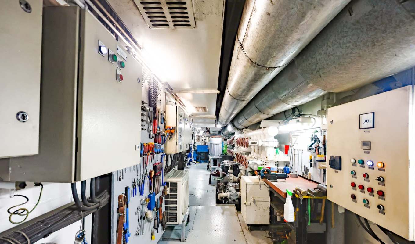 A narrow ship's engine room.