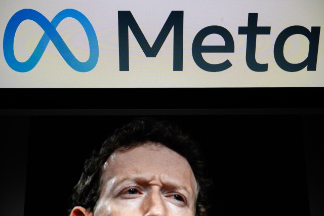 A close-up of Mark Zuckerberg with a serious expression, overlaid by the Meta logo on a screen.