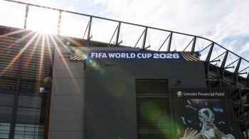 The exterior of Lincoln Financial Field, featuring a FIFA World Cup 2026 banner and sunlight streaming in.