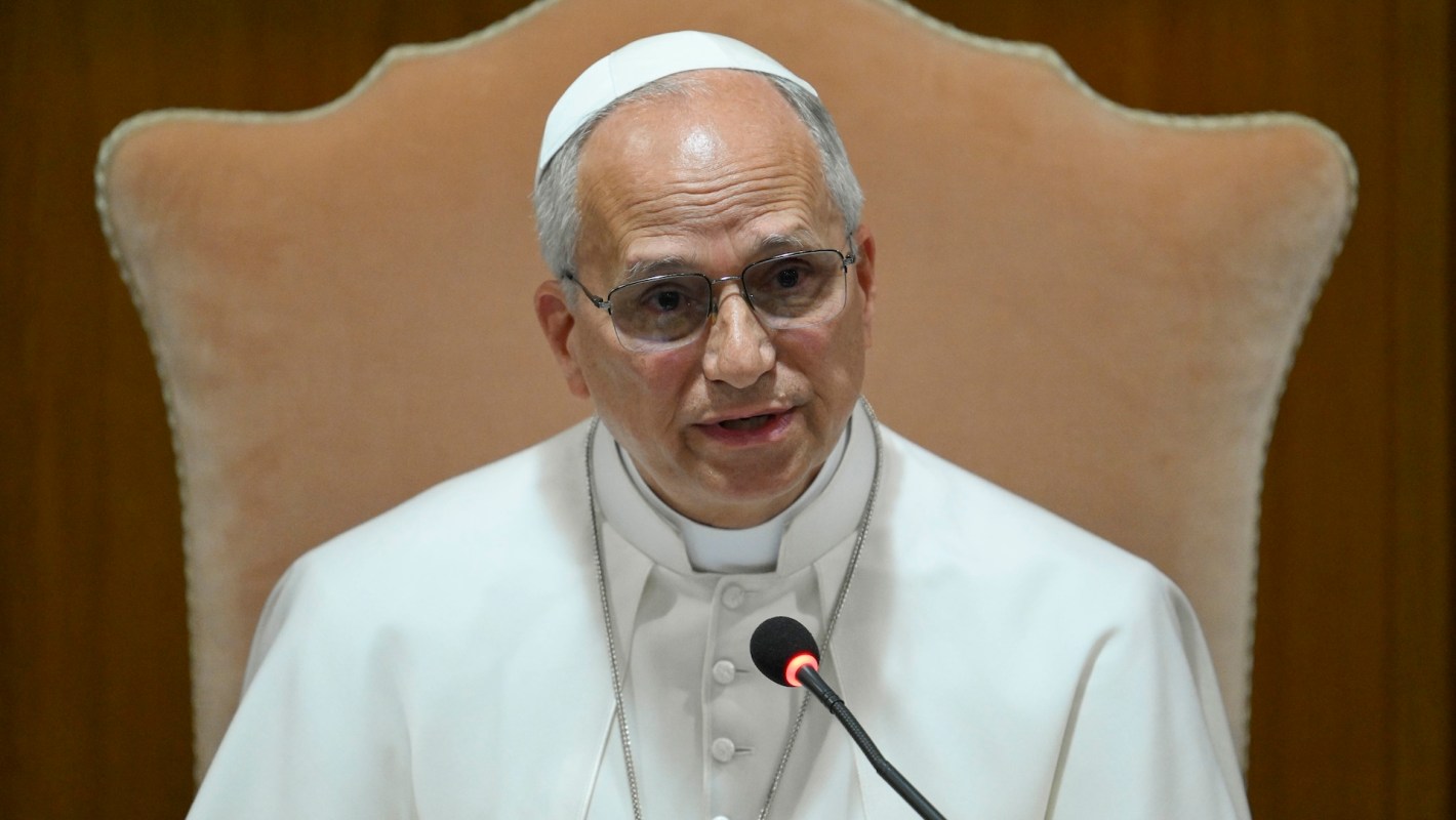 Pope Leo XIV speaking into a microphone.