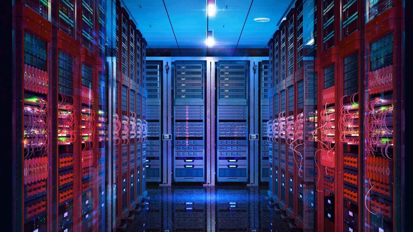 A data center corridor lined with illuminated server racks and colorful cables.