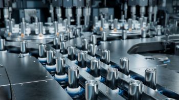 A close-up view of a high-tech manufacturing machine with metallic components and intricate mechanical parts.