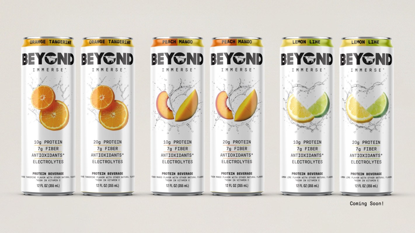 Six cans of Beyond Immerse protein beverages in orange tangerine, peach mango, and lemon lime flavors.