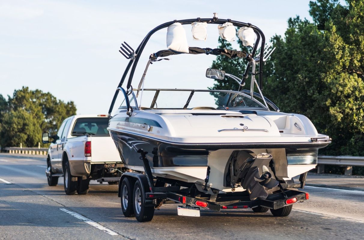 A pickup truck towing a boat.