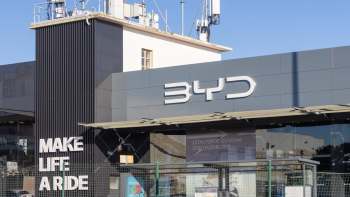 A modern retail building featuring the BYD logo and the phrase "MAKE LIFE A RIDE" prominently displayed.