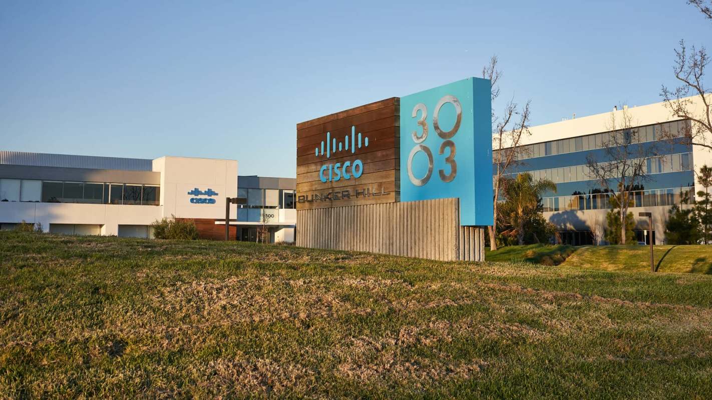 A Cisco office building with a prominent sign displaying "Bunker Hill" and "3003" in a grassy area.