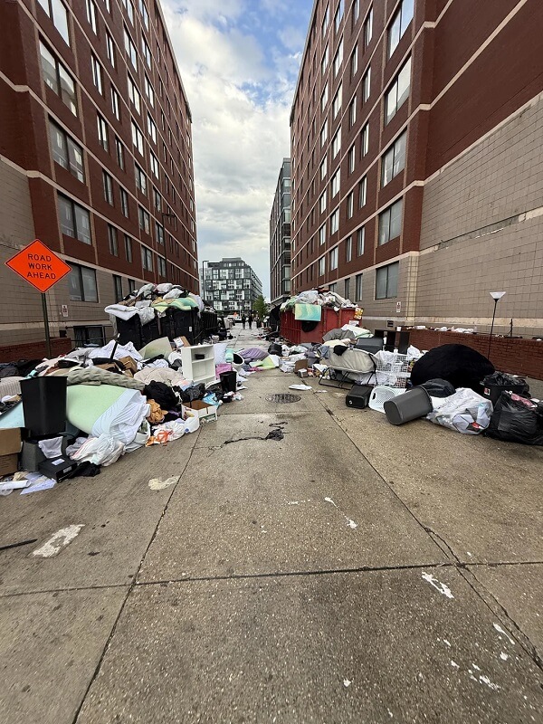 Overflowing dumpsters on the side of the road during college moveout.