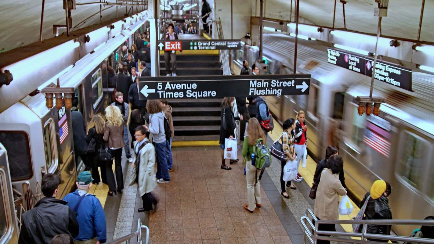 A busy subway station platform.