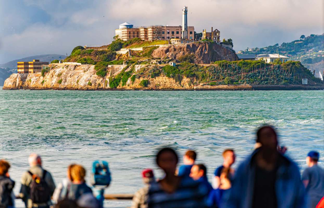 Alcatraz Island with tourists in the foreground.