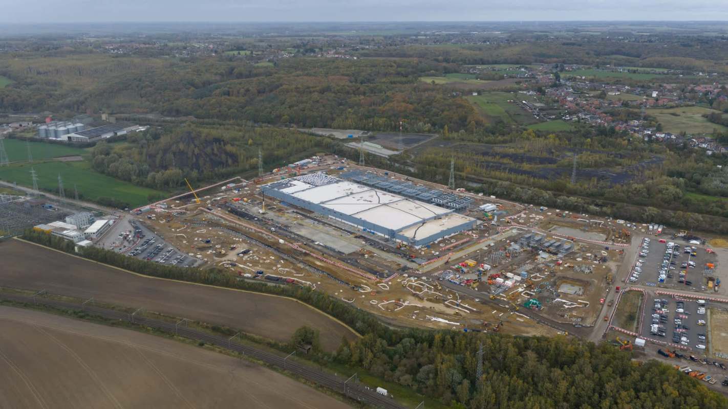 A construction site with a large building and machinery