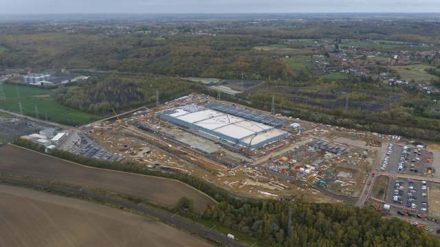 A construction site with a large building and machinery
