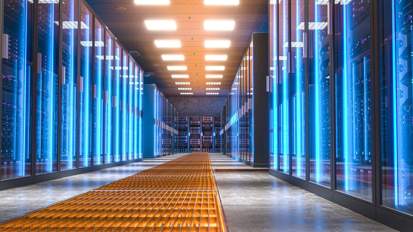 A futuristic data center hallway lined with illuminated server racks and a metallic floor grate.