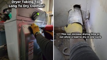 A person repairing a dryer while inspecting a dusty venting pipe in a cluttered laundry space.