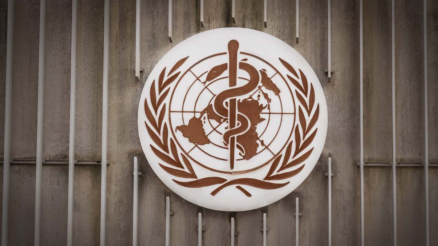 The World Health Organization logo featuring a caduceus and globe, surrounded by an olive wreath.
