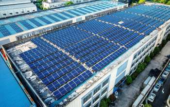 Many solar panels on a building.