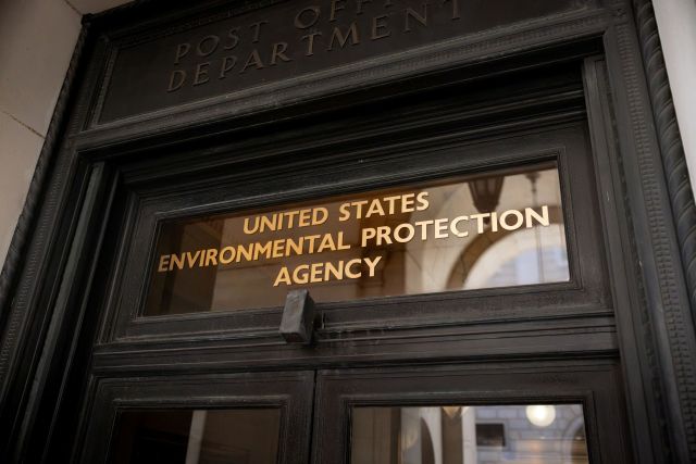 The entrance to the United States Environmental Protection Agency, featuring gold lettering on a dark door.