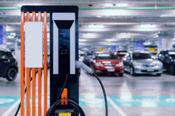 Electric vehicle charger in parking garage.