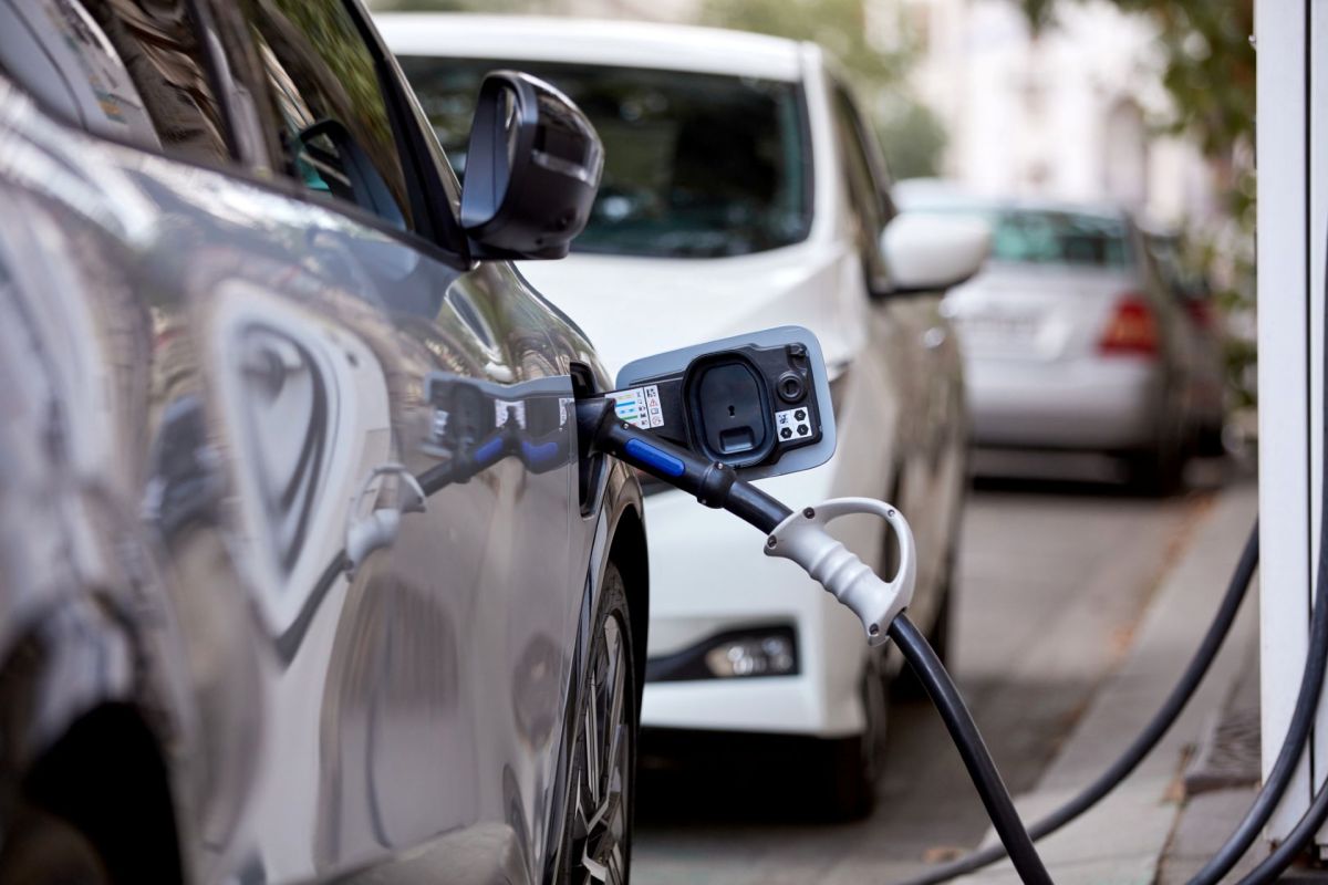 An EV charging on a city street.