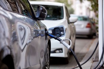 An EV charging on a city street.