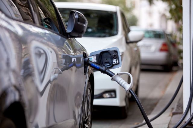 An EV charging on a city street.