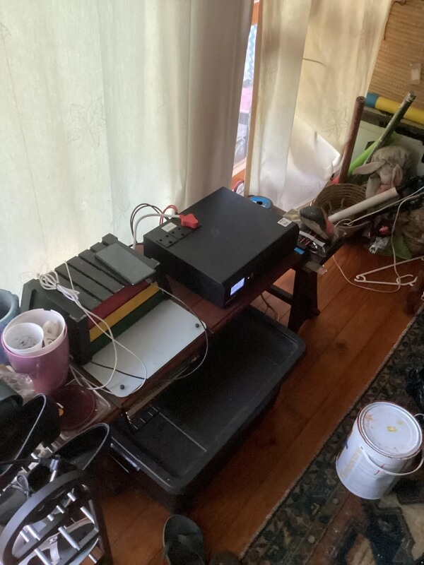 A fuse, charge controller, battery, and inverter for the Redditor's solar panels next to a window.
