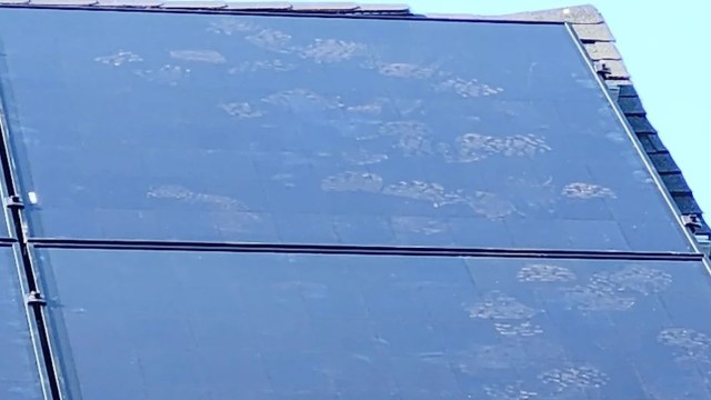 Footprints are visible on a solar panel, indicating recent activity or movement across its surface.