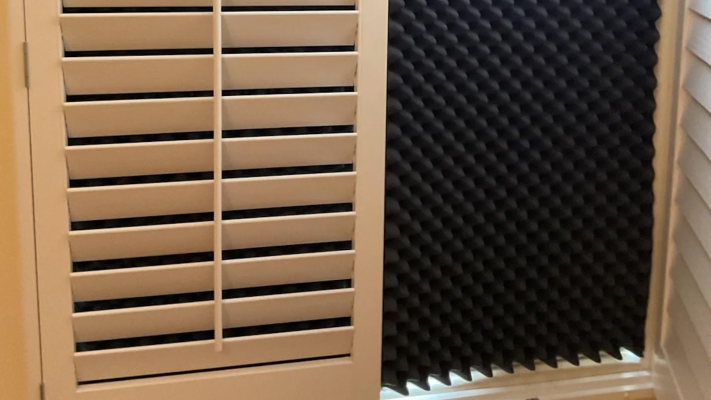 A black piece of acoustic foam in a window to block the sun.