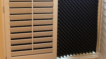 A black piece of acoustic foam in a window to block the sun.