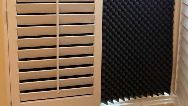 A black piece of acoustic foam in a window to block the sun.