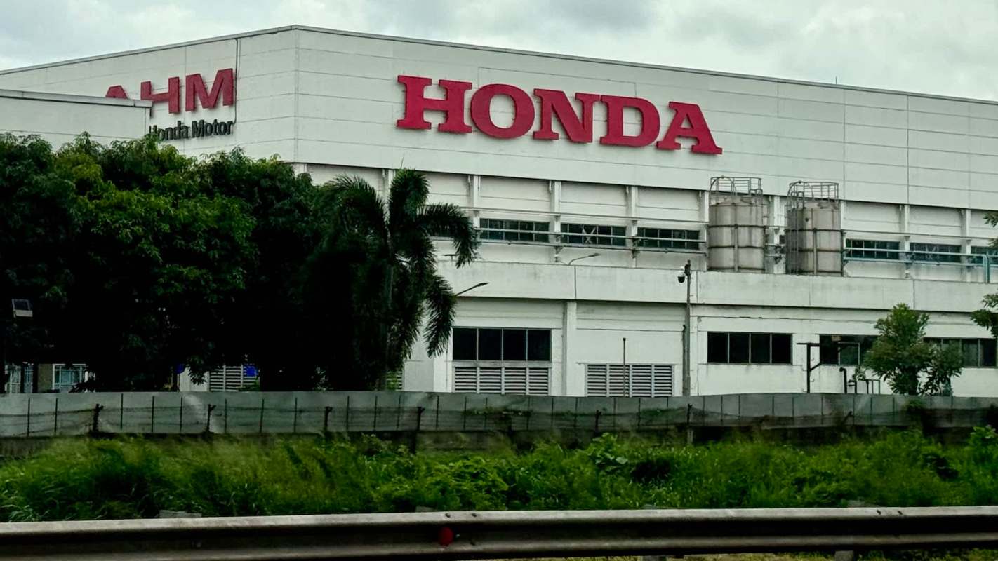 A Honda manufacturing facility surrounded by greenery and industrial equipment.