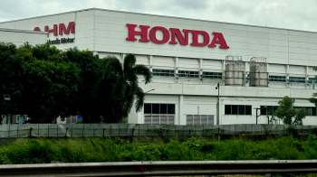 A Honda manufacturing facility surrounded by greenery and industrial equipment.