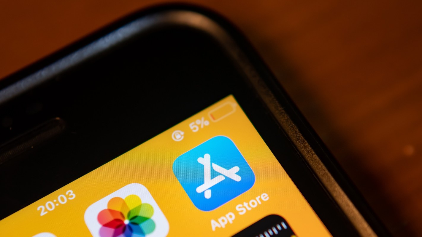 A smartphone screen showing the App Store icon and a low battery warning at 5%.