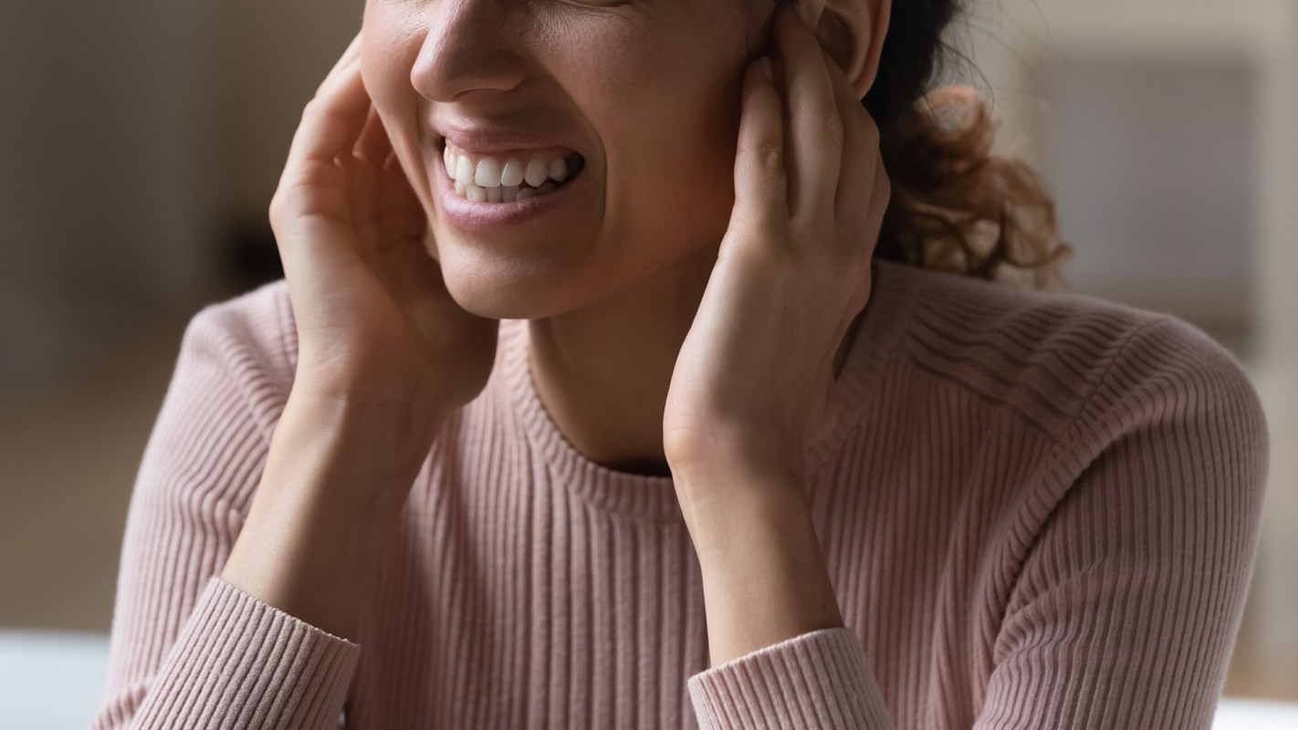 Someone plugging their ears.