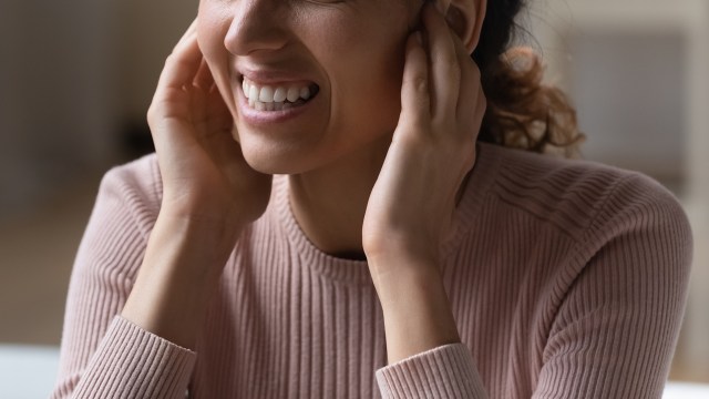 Someone plugging their ears.