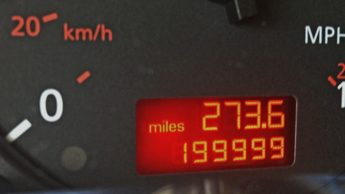 A vehicle's digital odometer displays 199,999 miles and trip mileage of 273.6 miles.