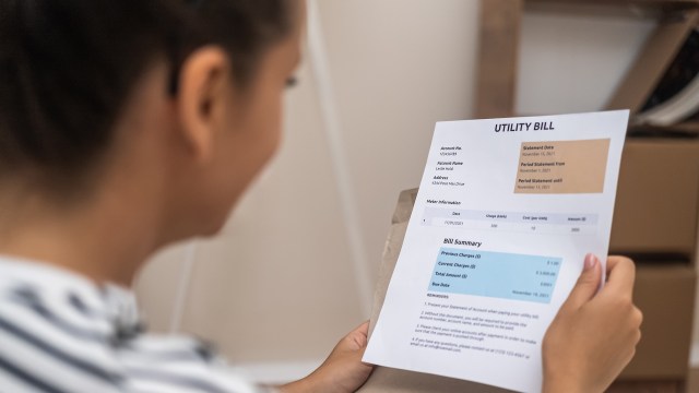 A person looking at a utility bill.