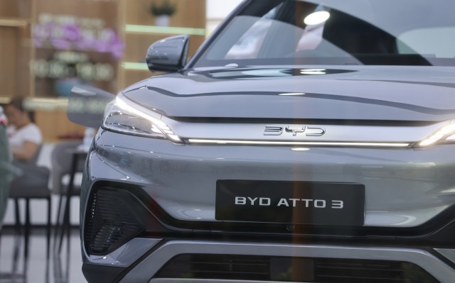 A close-up of a silver BYD Atto 3 electric vehicle displayed in a showroom.