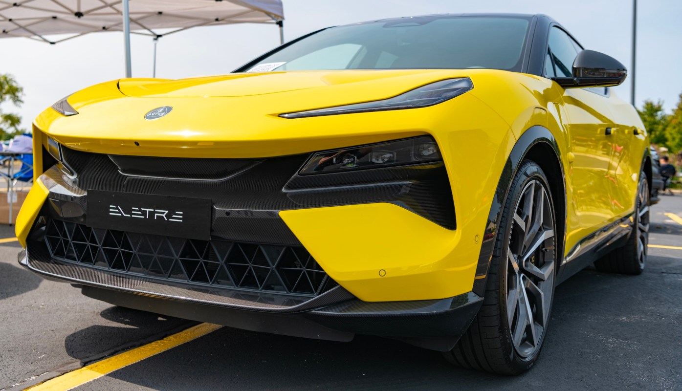 A close-up view of a vibrant yellow electric SUV parked, showcasing its sleek design and modern features.