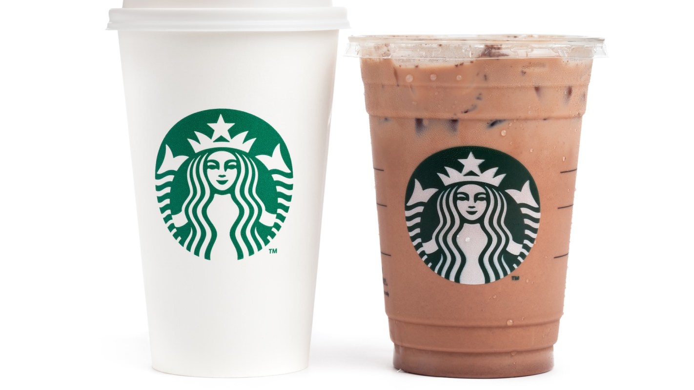 A white Starbucks cup and a transparent iced drink cup, both featuring the Starbucks logo.