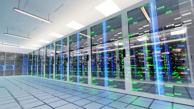 A data center featuring servers with illuminated indicators and glass enclosures.