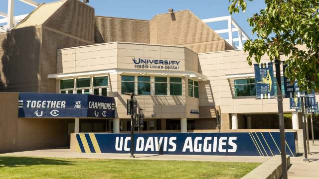 The exterior of the University Credit Union Center at UC Davis, featuring bold signage and banners.