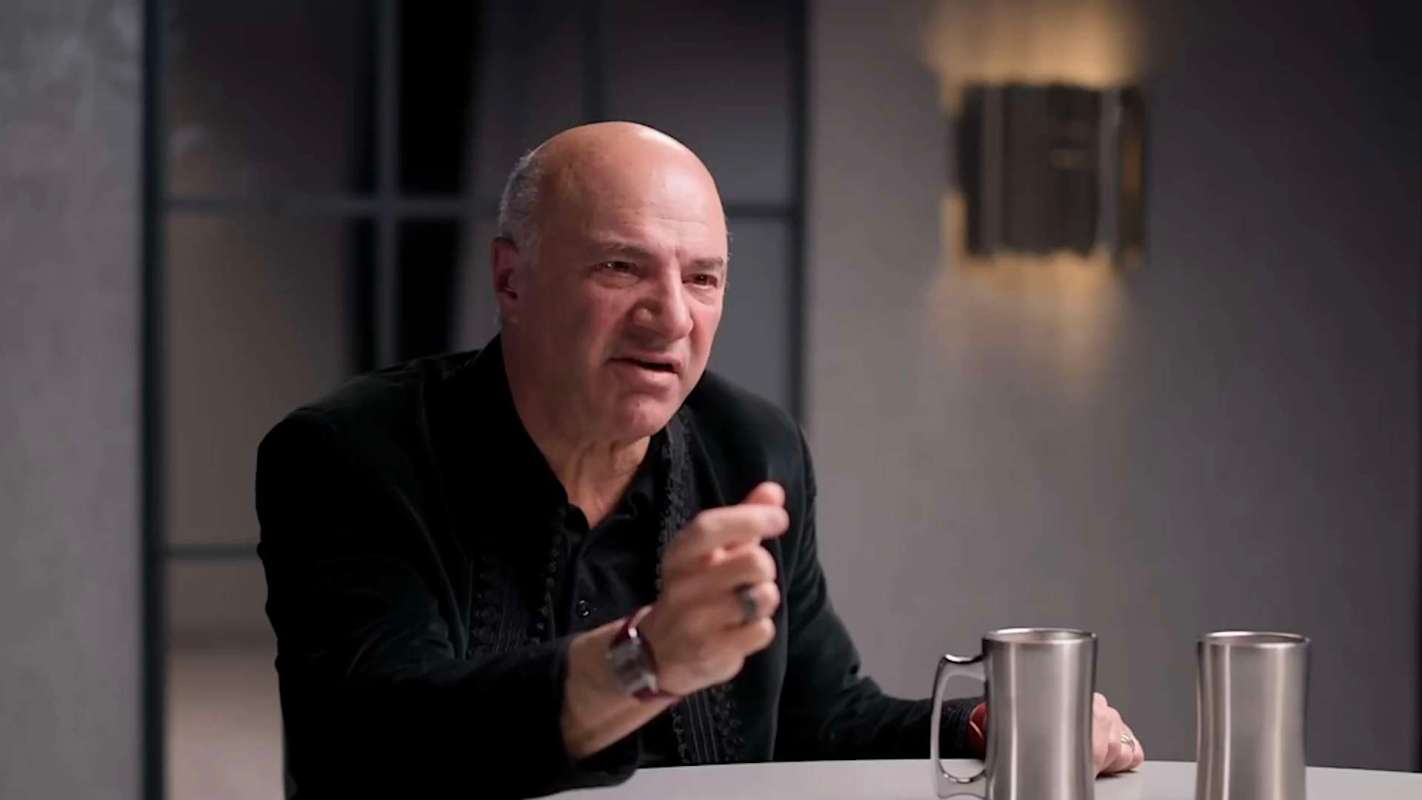 Kevin O'Leary wearing a black jacket and gesturing while speaking.