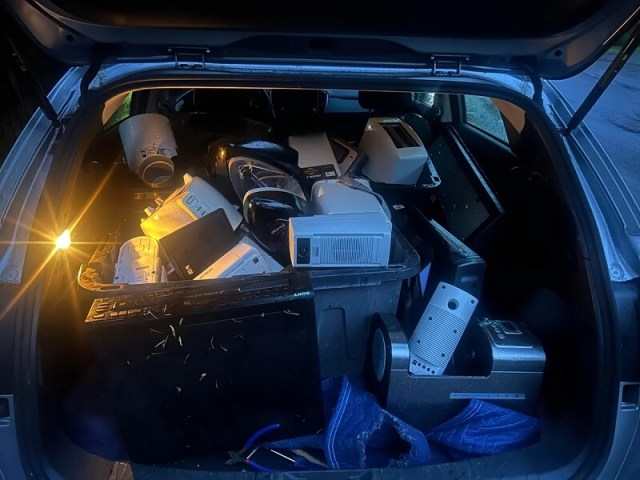 A car trunk full of small appliances.