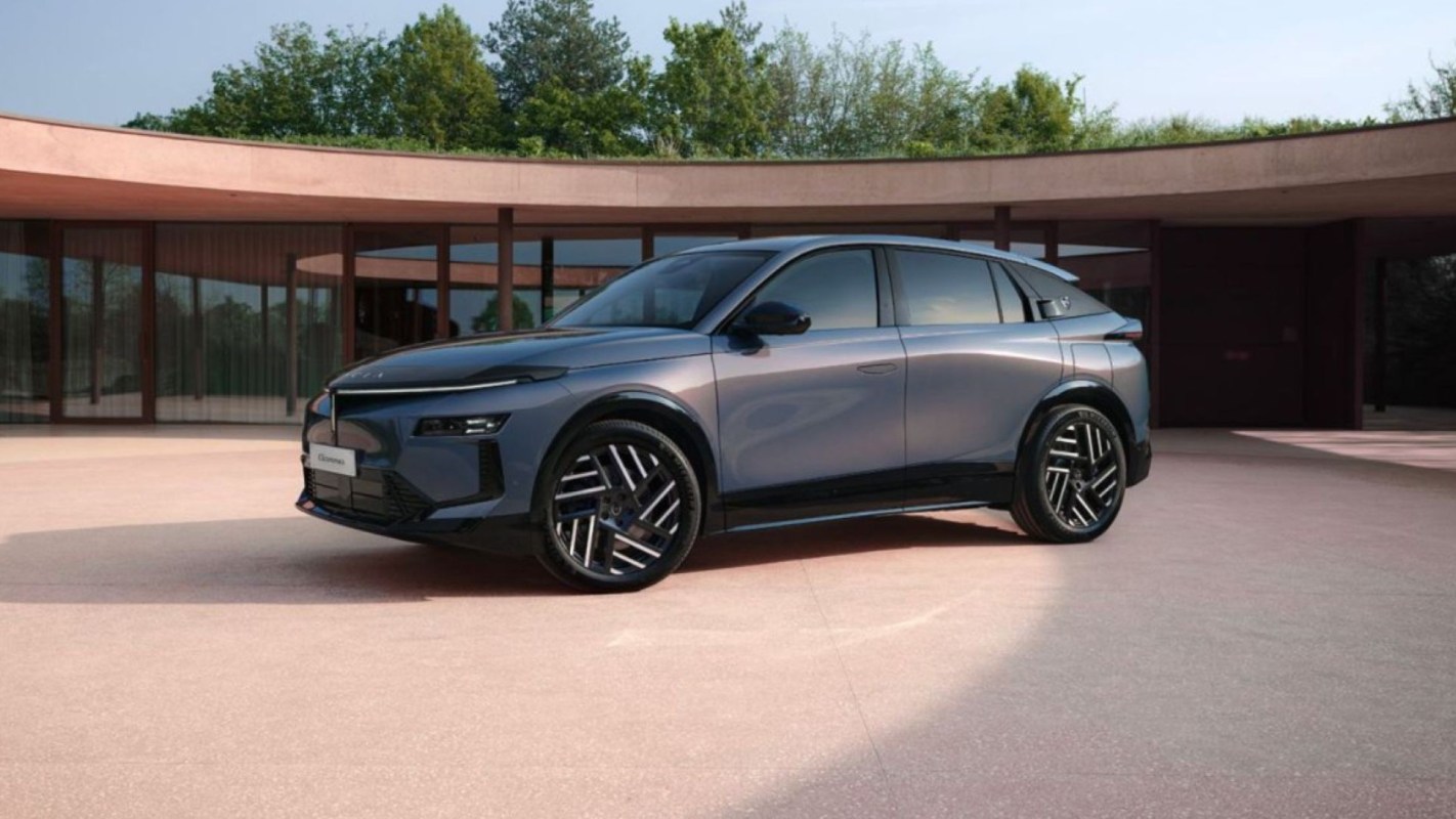A modern blue SUV parked in an elegant outdoor setting with a curved structure in the background.
