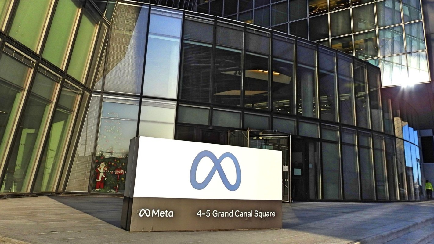 A modern glass building exterior with a Meta sign at the entrance, located at 4-5 Grand Canal Square.