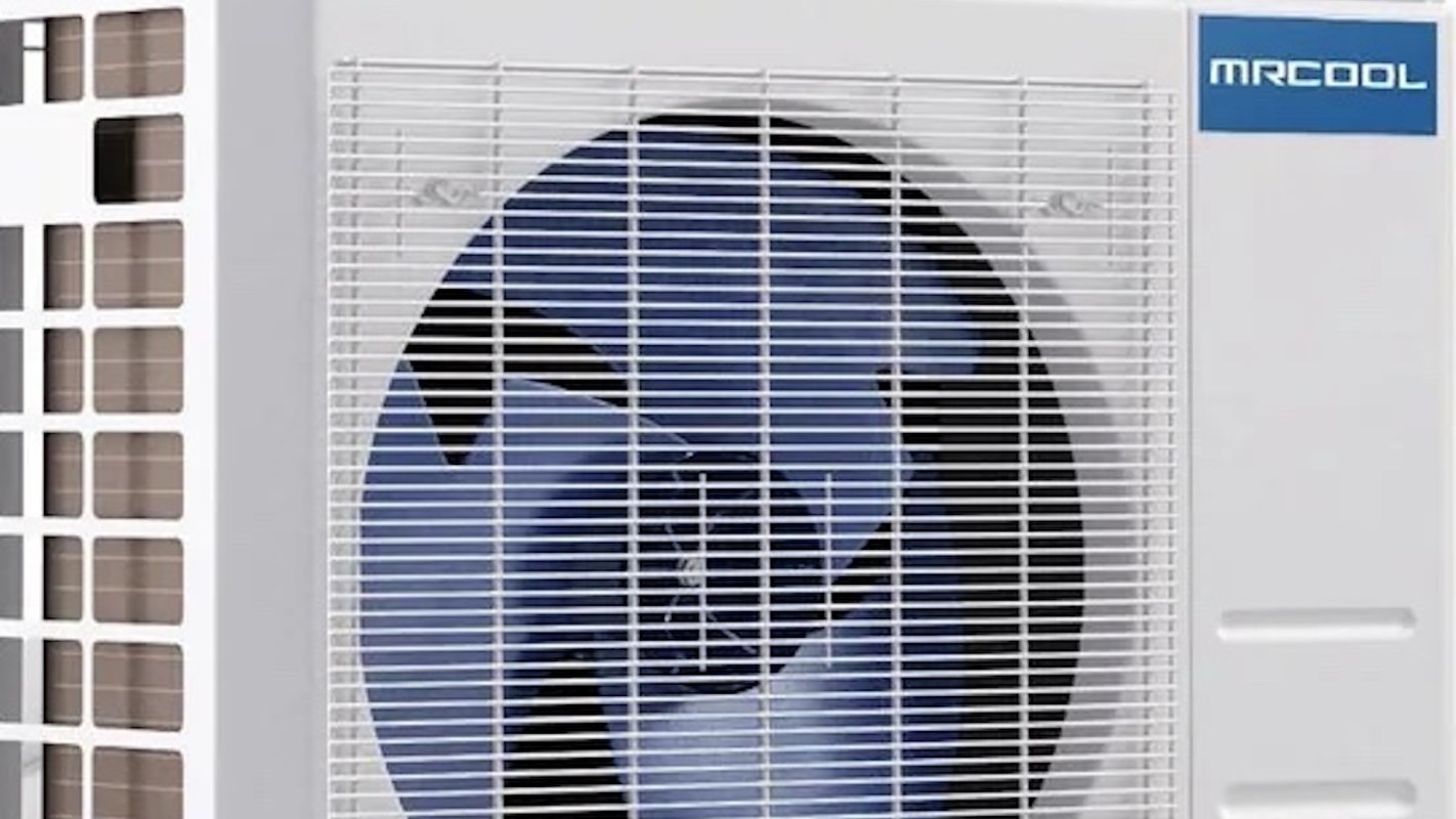 A close-up of an MRCOOL heat pump featuring a large fan and a slatted cover.